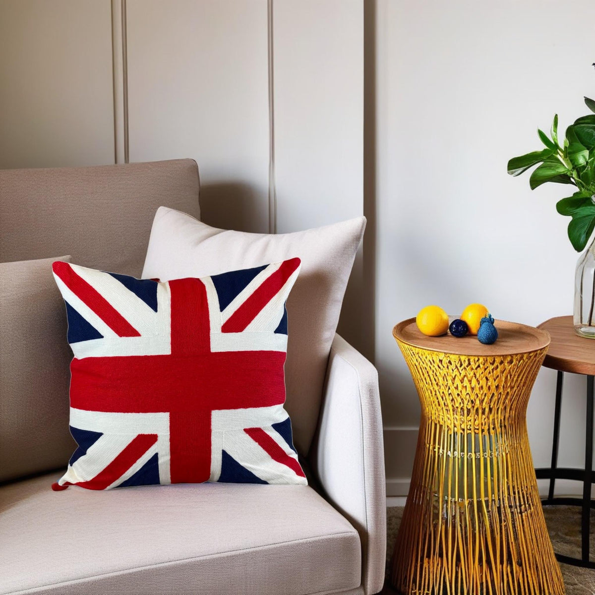 Red, white and blue Union Jack cushion on a beige sofa by a woven side table