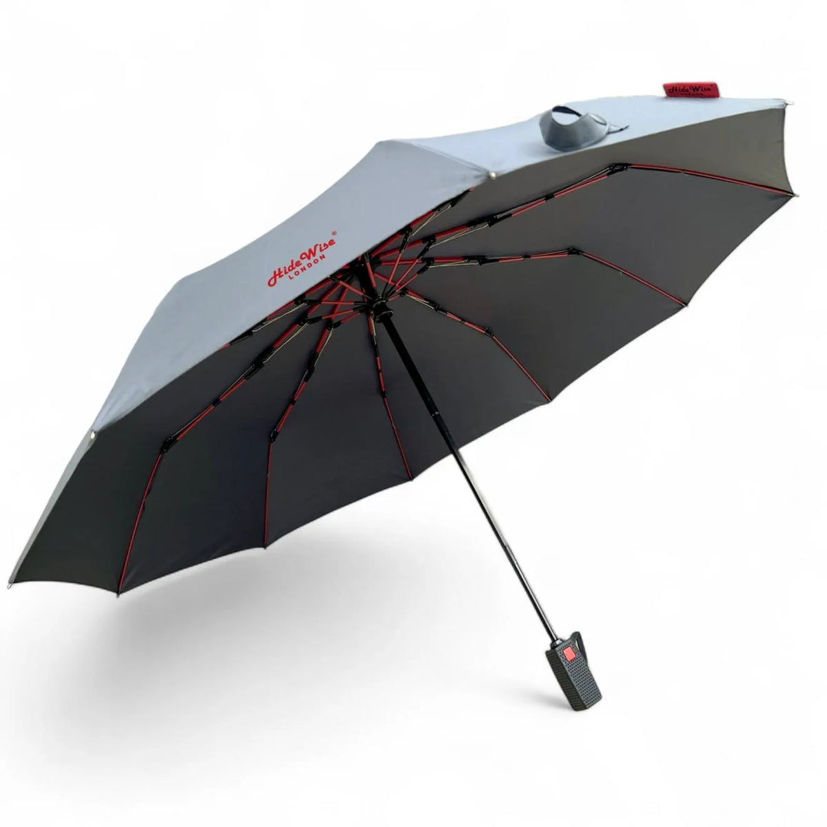 Grey windproof umbrella open, with red fibreglass-reinforced ribs under the canopy