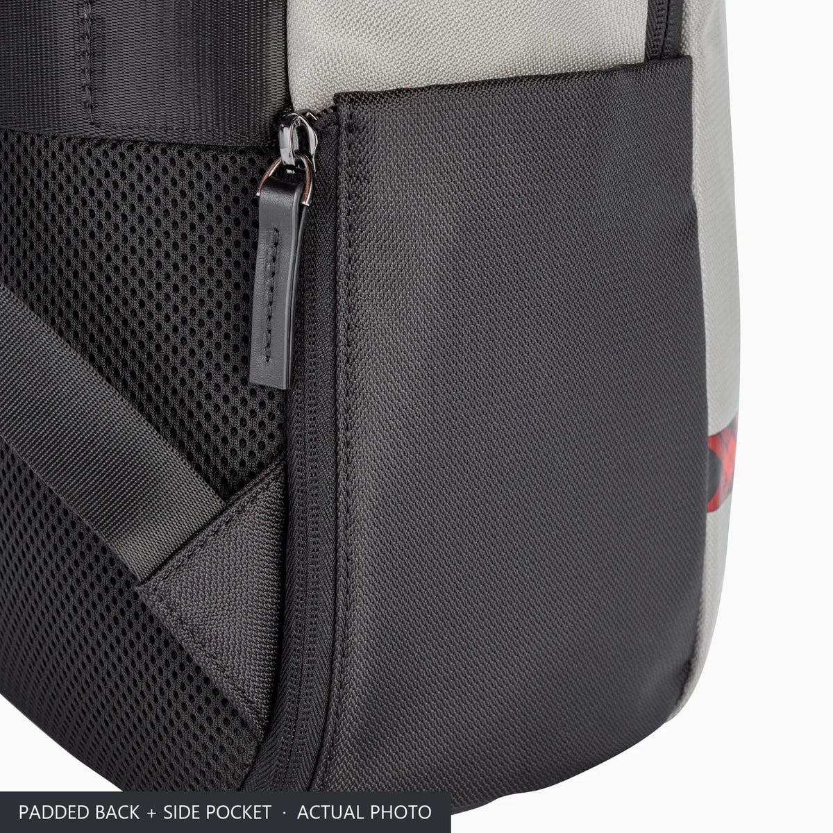 Padded back and black side pocket of the grey Porsche travel backpack