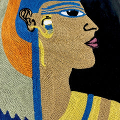 Close-up of the chain-stitch embroidery on the Cleopatra velvet cushion cover: face, earring and collar