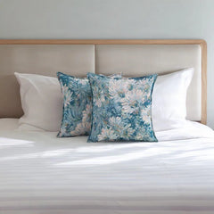 Floral tapestry cushion covers 50x50 cm on a white bed in front of a linen headboard