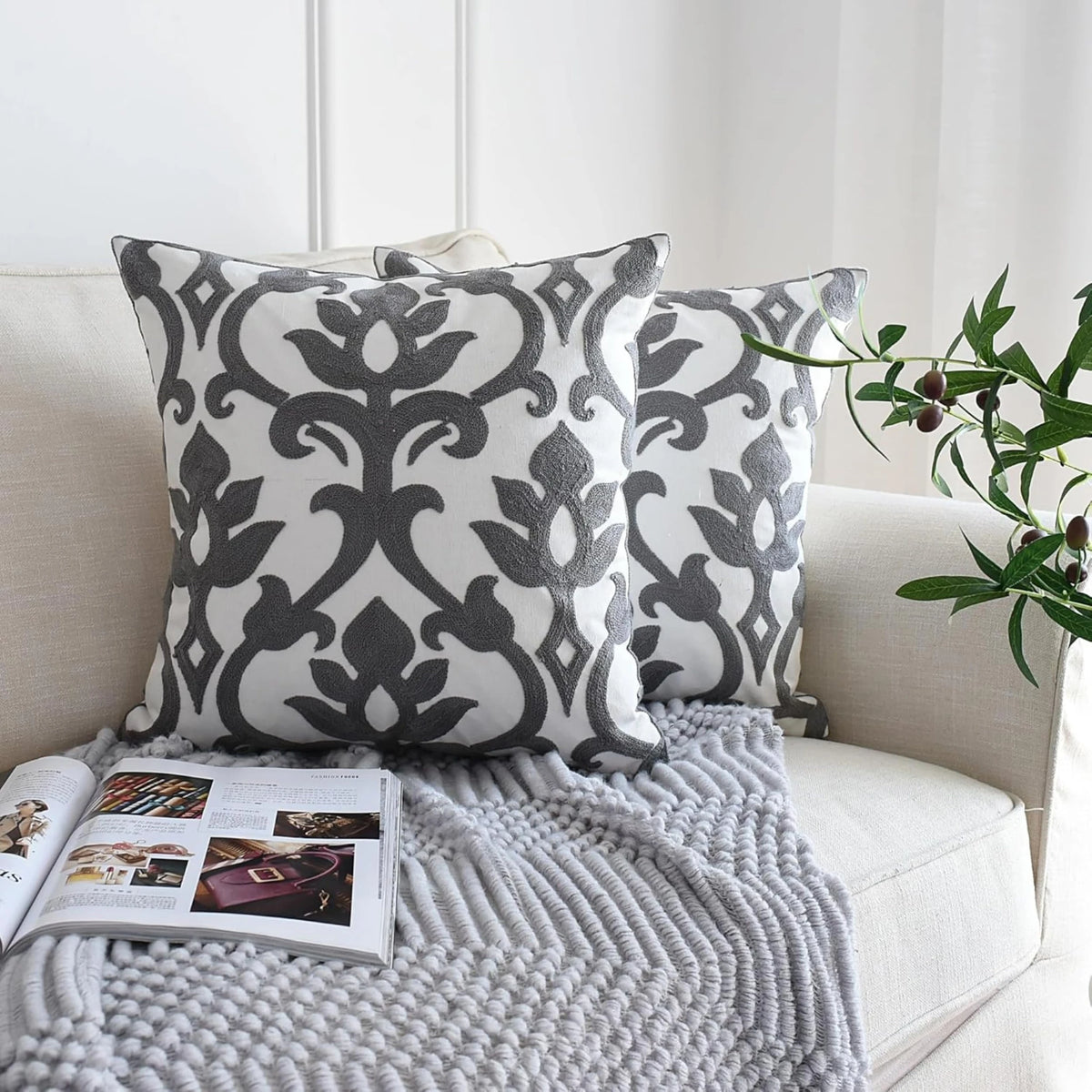 Embroidered cushion covers 50x50 cm, a set of 2 in grey and white Baroque bloom styled on a cream sofa