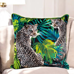 Lemon grass velvet cushion cover 50x50 cm with seated leopards, monstera leaves and lime piping on a cream sofa