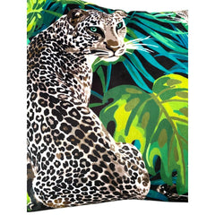 Close-up of the leopard jungle print velvet cushion cover: lime and emerald monstera leaves on a black ground