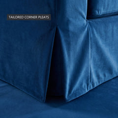 Close-up of the tailored corner pleats on the skirt of the blue velvet Ektorp sofa cover
