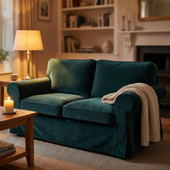 Ektorp 2 seat sofa dressed in a bottle green velvet replacement cover by lamplight, with a knitted throw