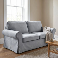 Grey velvet Ektorp sofa cover on a 2 seater in a bright sitting room, styled with a throw and coffee table
