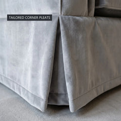 Close-up of the tailored corner pleats on the skirt of the grey velvet Ektorp sofa cover