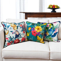 Tropical velvet cushion covers set of 3 on a white sofa: toucan, teal fruit and ivory floral prints