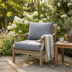 Grey outdoor cushions styled on a rattan patio sofa — IKEA Frösön and Duvholmen fit