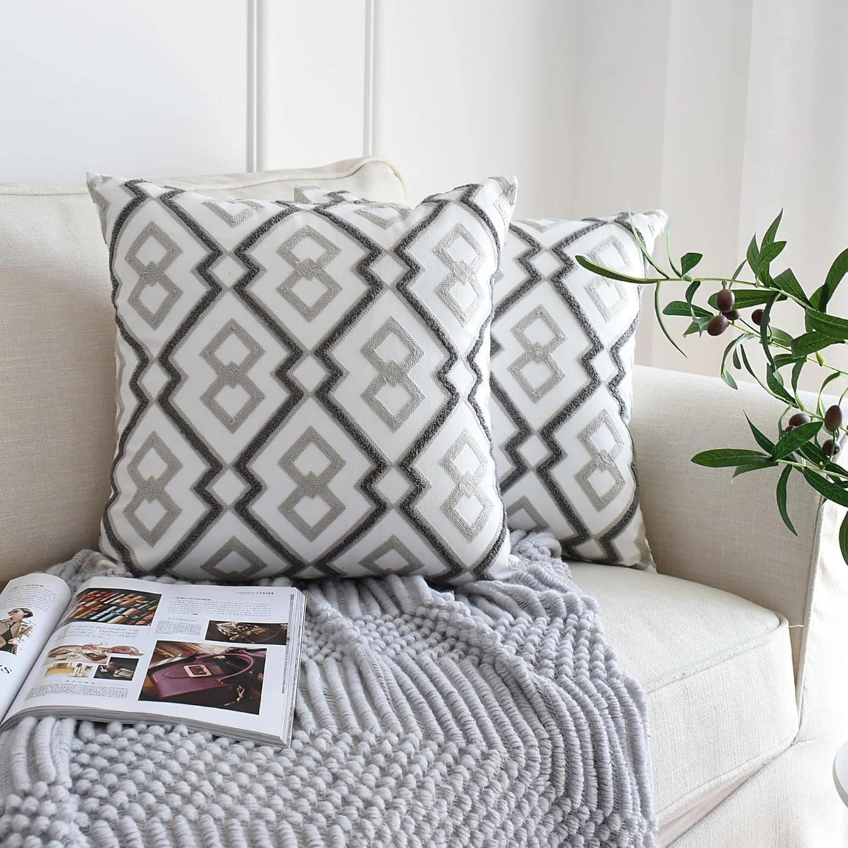 Embroidered cushion covers 50x50 cm, a set of 2 in grey and white Modern lattice styled on a cream sofa