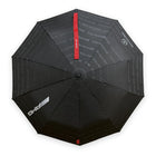 Mercedes-AMG compact folding umbrella, top view of the black canopy with AMG logo, Mercedes-Benz star and red AMG strap