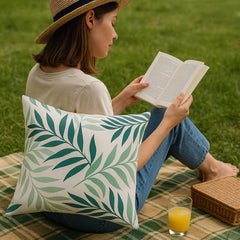 Green palm leaf cushions styled outdoors — garden patio sofa scatter pillows in use