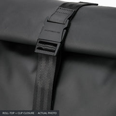 Clip buckle and webbing strap closing the roll top of the black Porsche 911 backpack