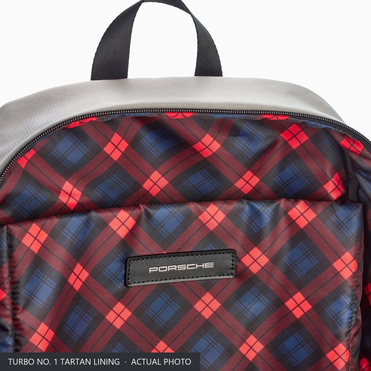Tartan check lining inside the Porsche Turbo No. 1 rucksack with the PORSCHE badge