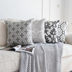 Embroidered cushion covers 50x50 cm set of 4: Moroccan trellis, Art Deco waves, baroque bloom and lattice on a cream sofa