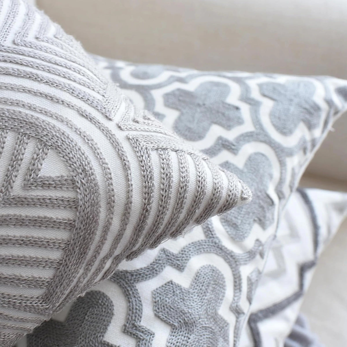 Raised grey stitching on the Art Deco waves and Moroccan trellis cushion covers, seen up close