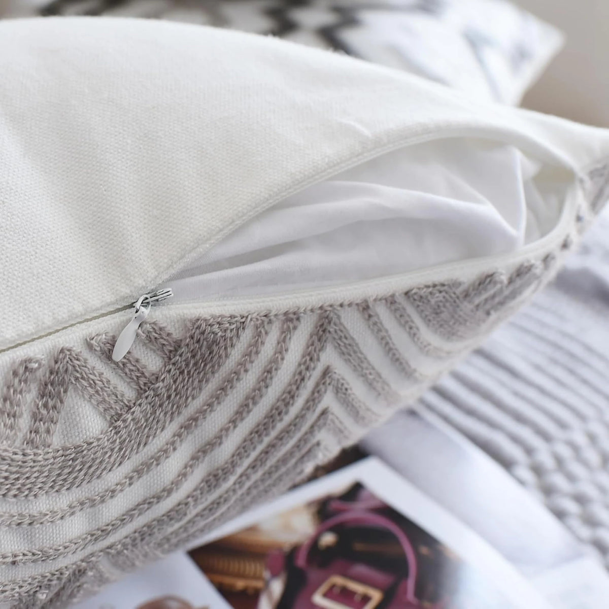 Hidden zip in the edge seam of an embroidered cotton cushion cover from the grey and white set of 4