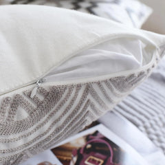 Hidden zip in the edge seam of an embroidered cotton cushion cover from the grey and white set of 4