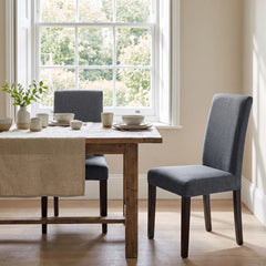 Two IKEA Bergmund chairs in grey replacement covers at a farmhouse dining table
