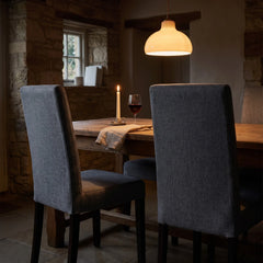 Graphite grey dining chair covers on Bergmund chairs at a candlelit table
