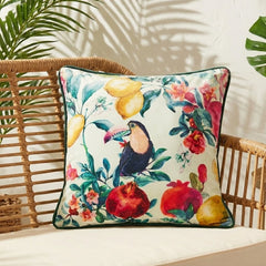 Tropical bird velvet cushion cover on a rattan bench with palm-leaf shadows on the wall